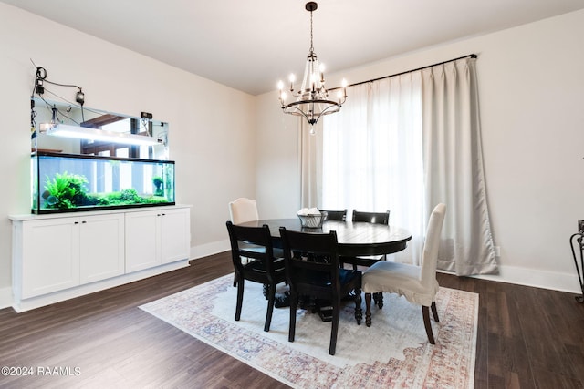 dining space with a notable chandelier and dark hardwood / wood-style floors