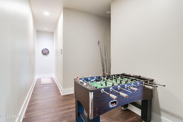 rec room with baseboards and wood finished floors