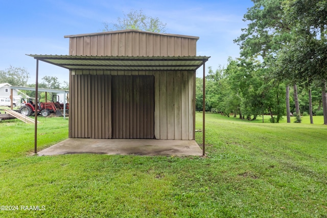 view of outbuilding featuring a lawn and a carport