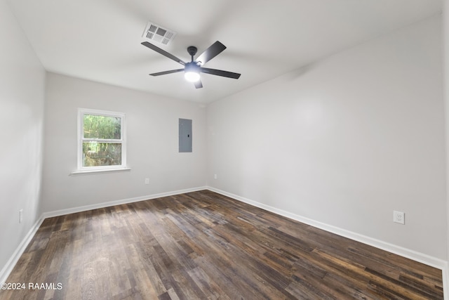 unfurnished room featuring ceiling fan, electric panel, and dark hardwood / wood-style flooring