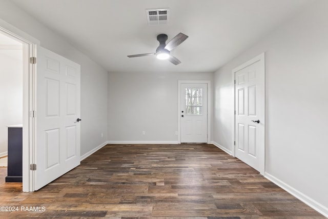 interior space with ceiling fan and dark wood-type flooring