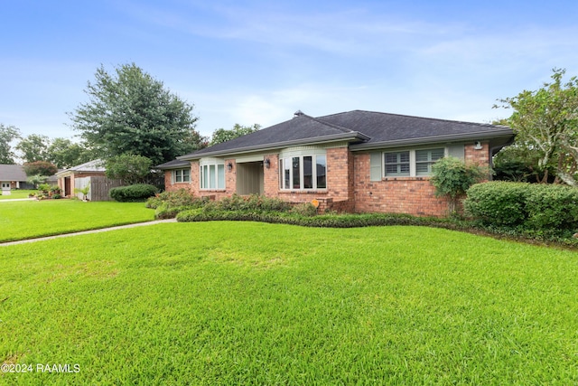 ranch-style home with a front yard