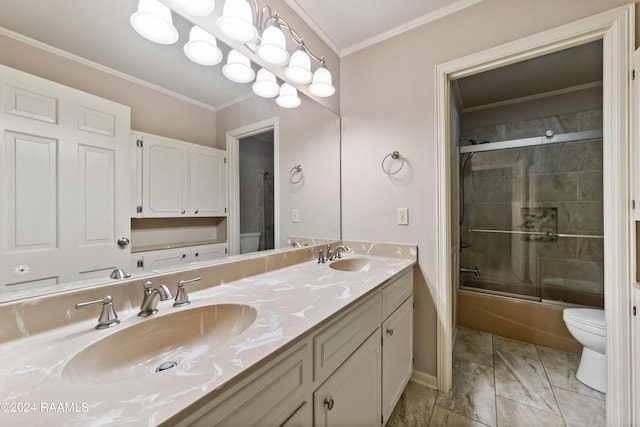 full bathroom featuring toilet, ornamental molding, bath / shower combo with glass door, and vanity