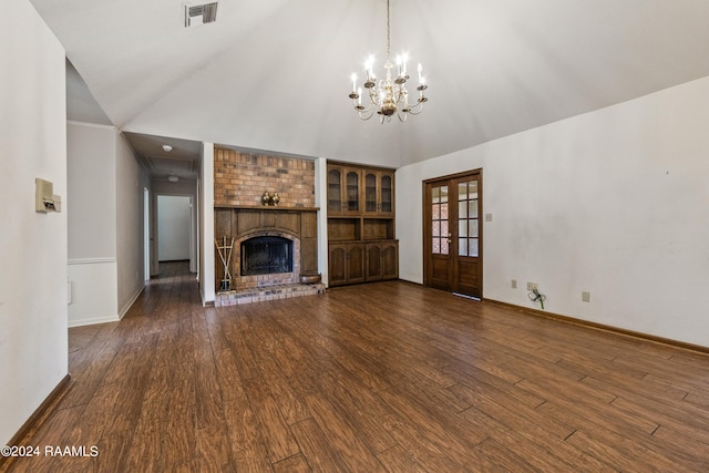 unfurnished living room with a brick fireplace, high vaulted ceiling, a notable chandelier, and dark hardwood / wood-style flooring