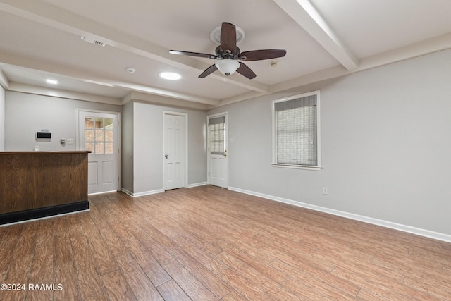 interior space with beam ceiling, ceiling fan, and hardwood / wood-style flooring