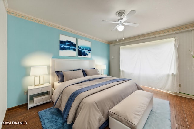 bedroom with dark hardwood / wood-style flooring, ornamental molding, and ceiling fan