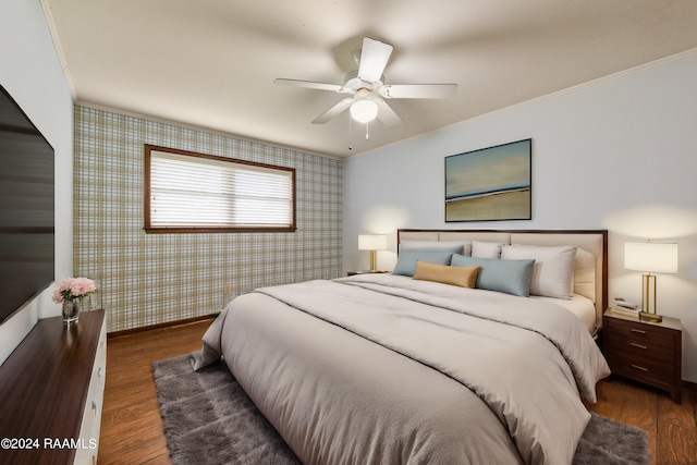 bedroom with dark wood-type flooring, ornamental molding, and ceiling fan