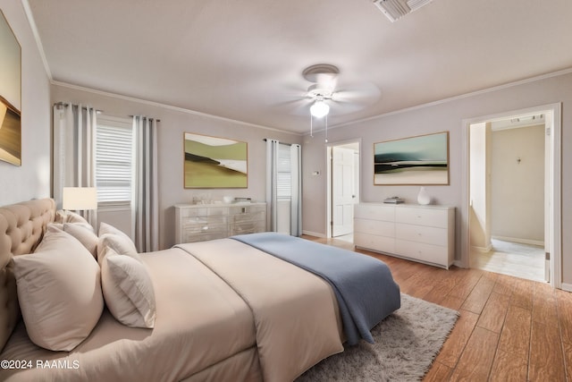 bedroom featuring ornamental molding, ceiling fan, and light hardwood / wood-style flooring