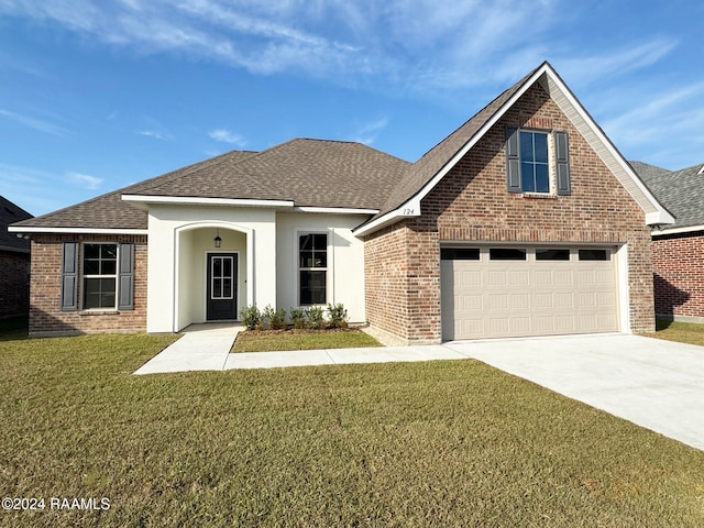 view of front of home with a garage and a front yard