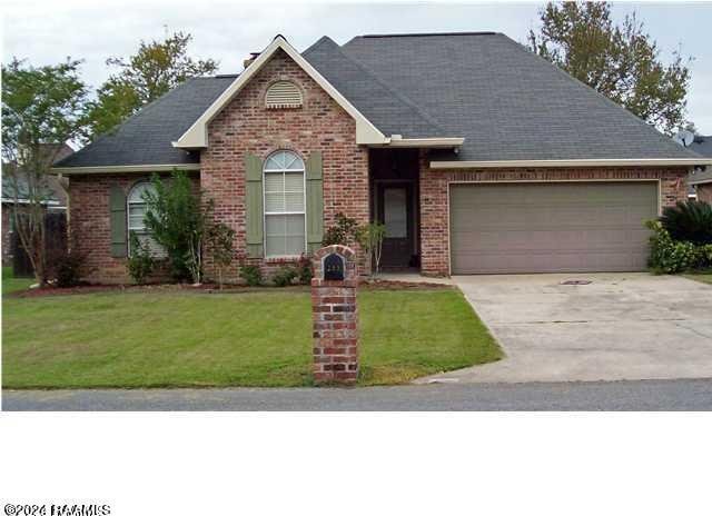 view of front of home featuring a garage and a front lawn