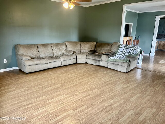 living room with ceiling fan, ornamental molding, and light hardwood / wood-style floors