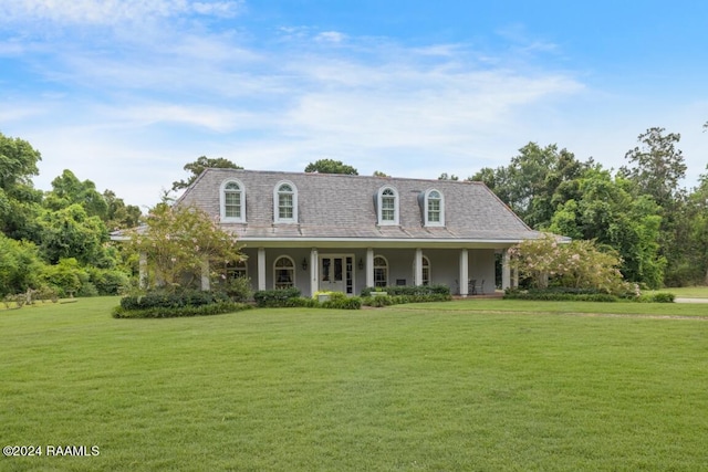 view of front of home with a porch and a front lawn