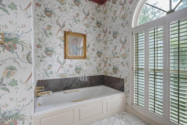 bathroom with a tub to relax in