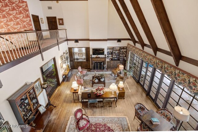 living room with hardwood / wood-style flooring and a towering ceiling