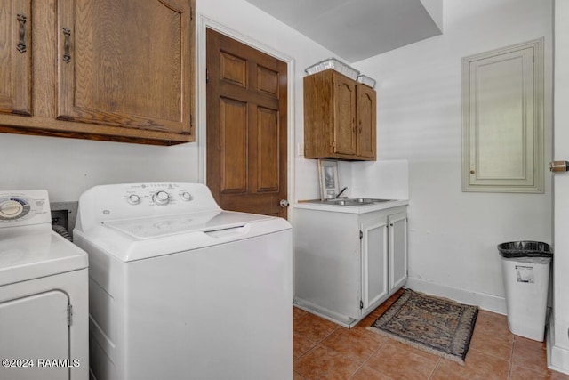 laundry room with cabinets, sink, washer and dryer, and light tile patterned floors