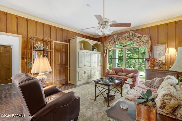 living room featuring crown molding, ceiling fan, and wood walls