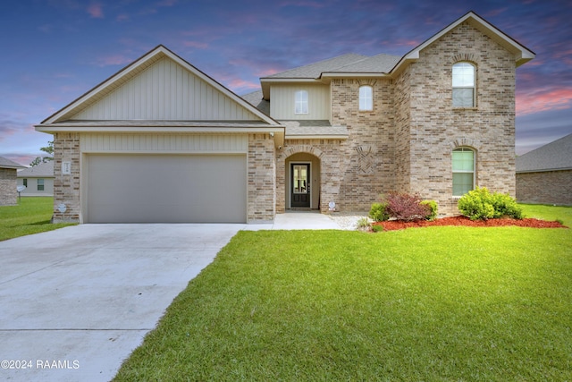 view of front of house with a garage and a yard