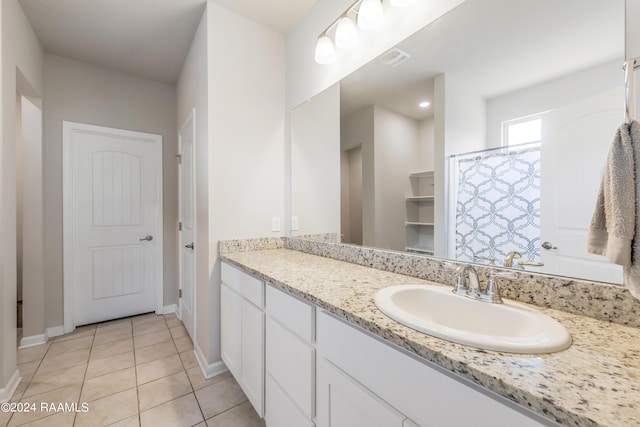 bathroom featuring tile patterned flooring and vanity