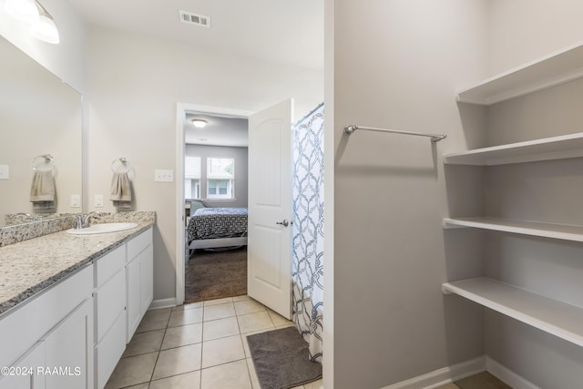 bathroom with tile patterned flooring and vanity