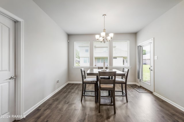 dining room with a chandelier and dark hardwood / wood-style floors