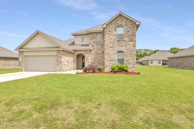 view of front of property with a garage and a front lawn