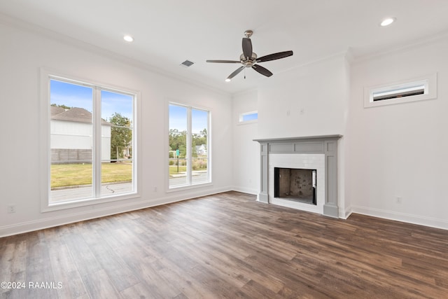 unfurnished living room with crown molding, ceiling fan, and dark hardwood / wood-style flooring