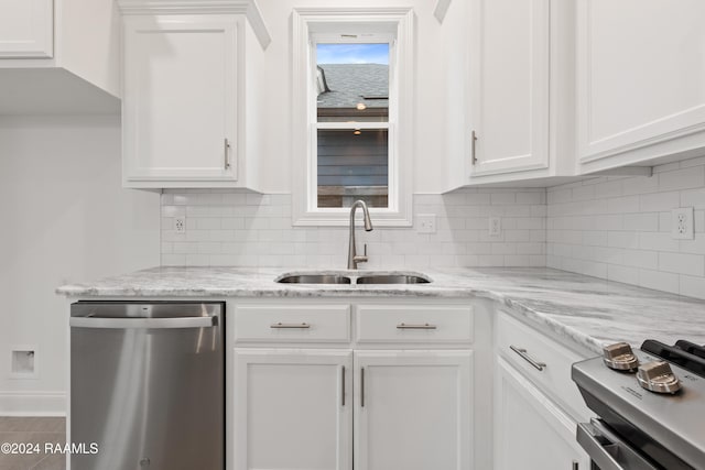 kitchen with white cabinetry, stainless steel dishwasher, range, and sink