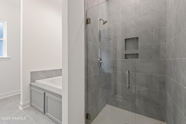 bathroom featuring tile patterned floors and separate shower and tub