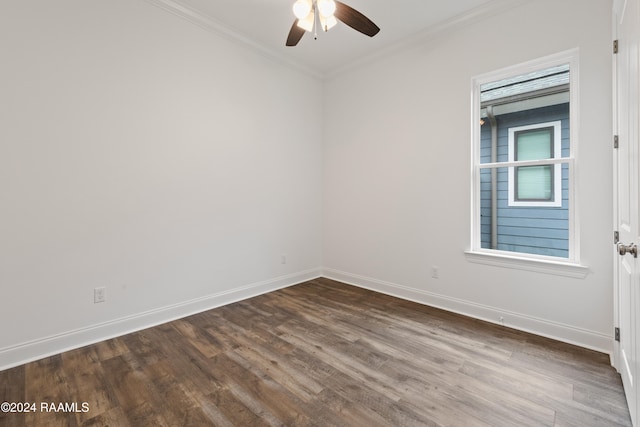 empty room featuring crown molding, dark wood-type flooring, and ceiling fan