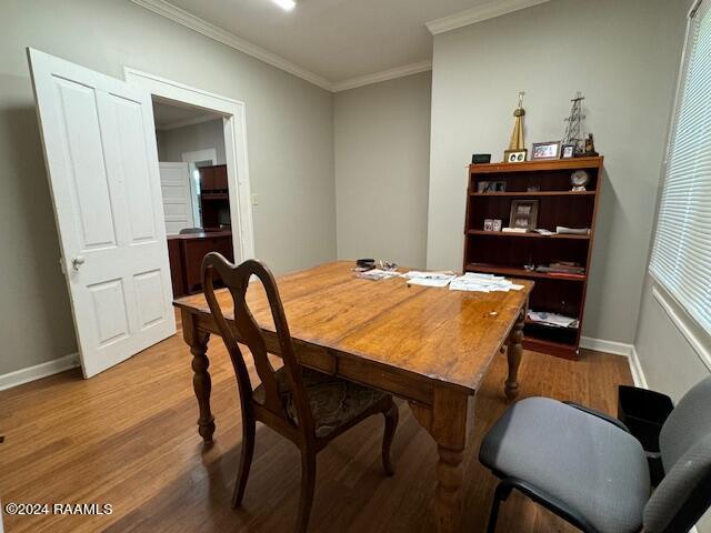 dining space with crown molding and wood-type flooring