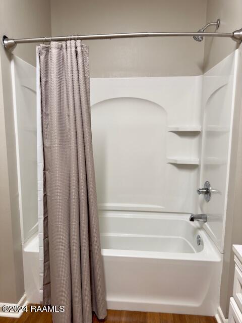 bathroom featuring vanity and shower / tub combo with curtain