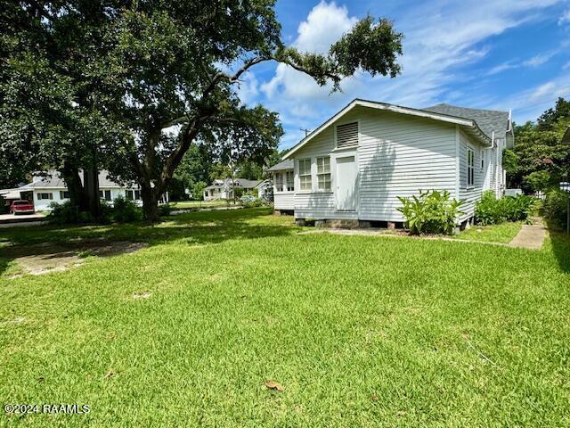 view of side of property with a yard