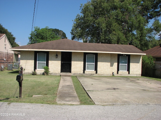 ranch-style home with a front lawn and central AC