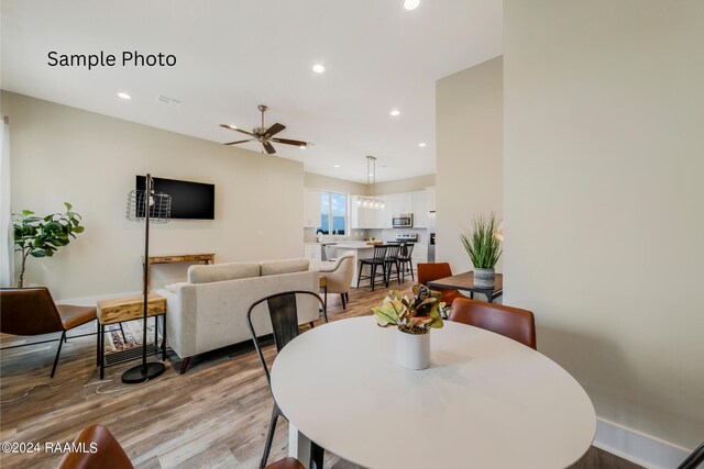 dining space featuring light hardwood / wood-style flooring and ceiling fan