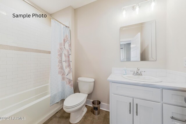 full bathroom featuring vanity, shower / bath combo with shower curtain, and toilet