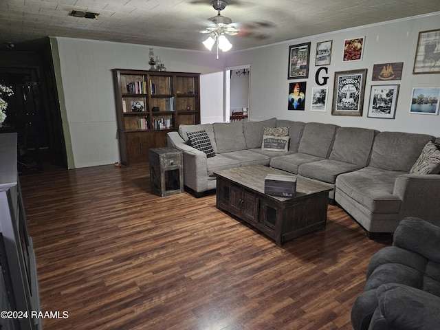 living room with ornamental molding, dark hardwood / wood-style floors, and ceiling fan