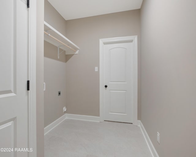 clothes washing area featuring baseboards, hookup for an electric dryer, and laundry area