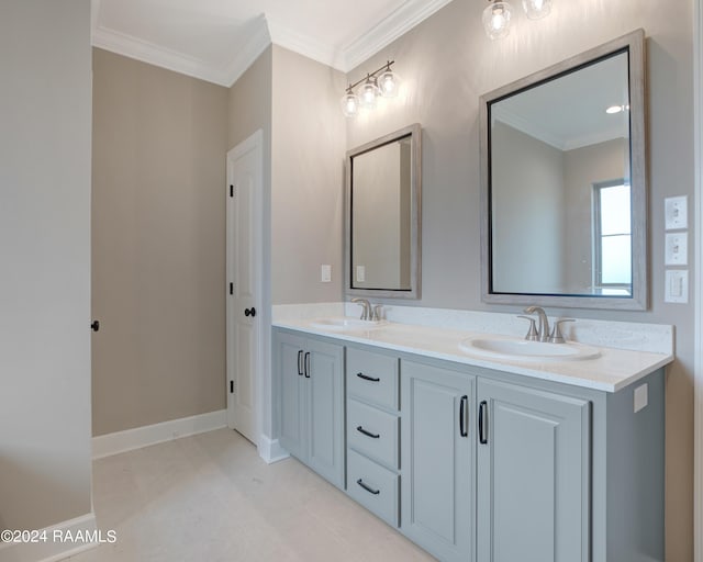 bathroom with a sink, ornamental molding, and double vanity