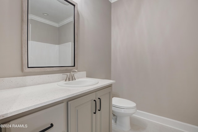 bathroom with vanity, toilet, baseboards, and ornamental molding