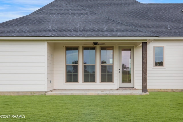 exterior space featuring a yard and roof with shingles