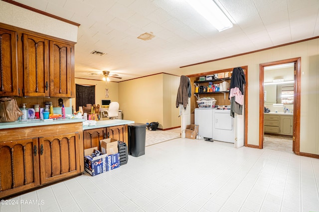 kitchen with light tile patterned flooring, ornamental molding, separate washer and dryer, and ceiling fan