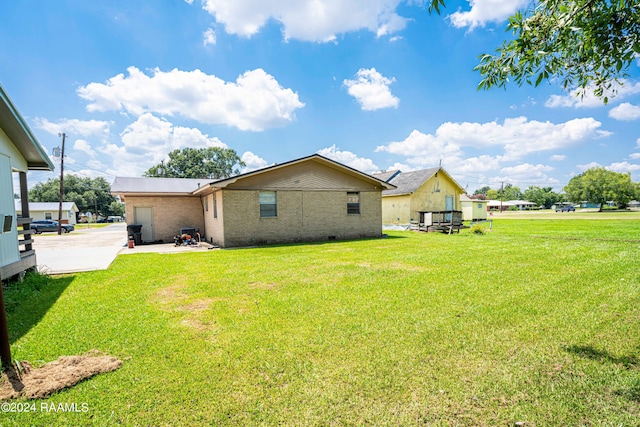 1605 Charity St, Abbeville, LA 70510 - exterior space featuring brick siding, a patio, and a lawn