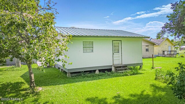 rear view of property with a yard