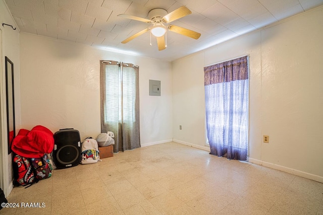 1605 Charity St, Abbeville, LA 70510 - spare room featuring electric panel, tile patterned floors, baseboards, and a ceiling fan