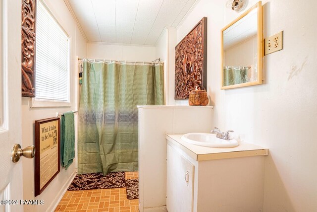 bathroom featuring vanity and ornamental molding