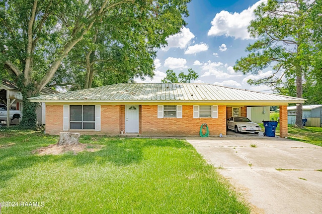 ranch-style home with a front yard and a carport