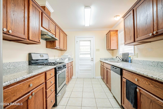 kitchen featuring sink, appliances with stainless steel finishes, light stone counters, ornamental molding, and light tile patterned flooring