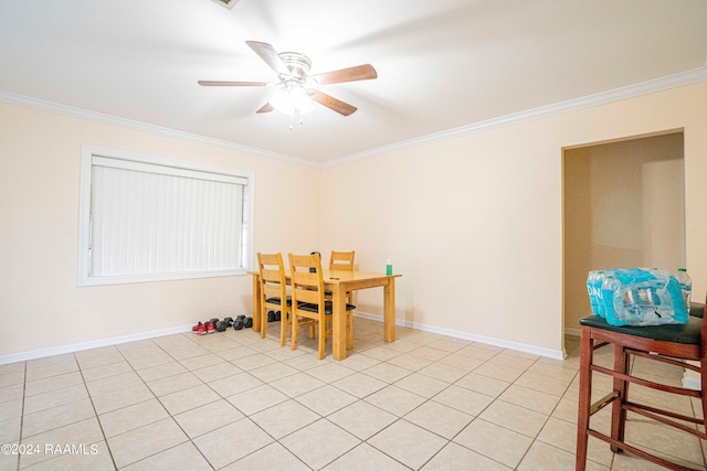 tiled dining area featuring ceiling fan and crown molding