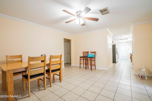 dining space featuring light tile patterned floors, crown molding, and ceiling fan