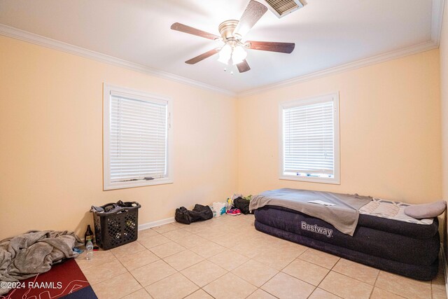 bedroom with light tile patterned flooring, ornamental molding, and ceiling fan